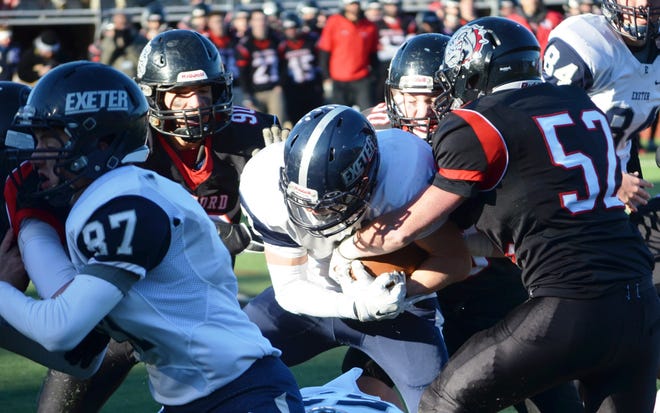 Exeter High School running back Shane Quimby, center, is swarmed by a group of Bedford defenders during Saturday's Division I semifinal football game. The Blue Hawks lost to Bedford 14-7. Ryan O'Leary photo