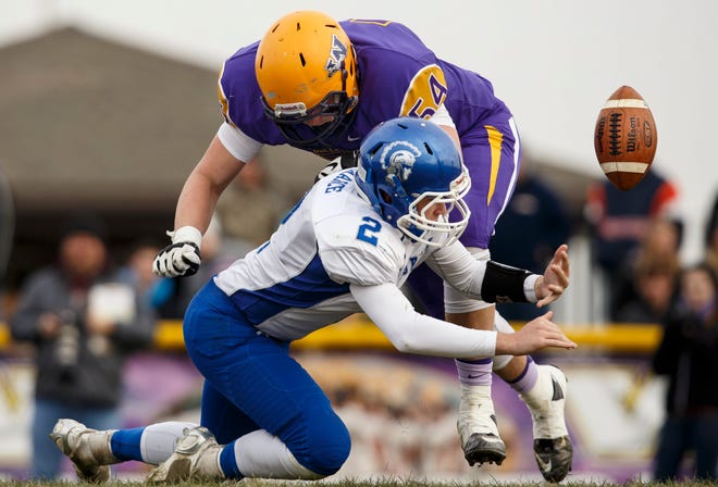 Williamsville's Mitch Whitley closes in on Auburn quarterback Drew Chance as he scrambles for a fumbled ball during the Class 3A high school football playoffs in Williamsville Saturday, Nov. 15, 2014. Ted Schurter/The State Journal-Register