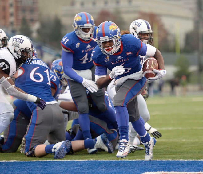 KU running back Corey Avery finds a hole for a touchdown in the first quarter of Saturday's game against TCU at Memorial Stadium.