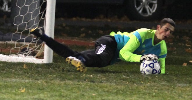 Mount Academy's Sheldon Hofer dives to make a save during Saturday's state Class D semifinal at Faller Field in Middletown. Will Montgomery/Times Herald-Record