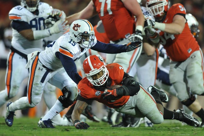 Georgia running back Todd Gurley (3) reacts with pain while being tackled during an NCAA college football game between Georgia and Auburn on Saturday, Nov. 15, 2014, in Athens, Ga. Gurley came off the field after the play. (AJ Reynolds/Staff, @ajreynolds)