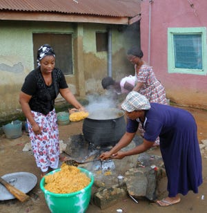 Women of the Igbo Jewish community in Abuja, Nigeria, prepare vast quantities of spicy rice in preparation for the Sabbath and its many guests, including Providence Rabbi Barry Dolinger and his wife, Naomi Baine.