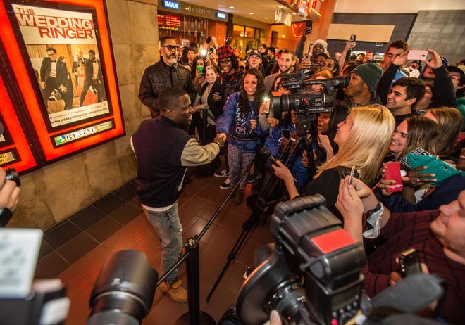 Actor and comedian Kevin Hart shakes a fan’s hand while being interviewed outside Regal Valley River Center Stadium 15 movie complex before a showing of his film “The Wedding Ringer.” Hart also brought his comedy to Matthew Knight Arena on Saturday night. (Brian Davies/The Register-Guard)