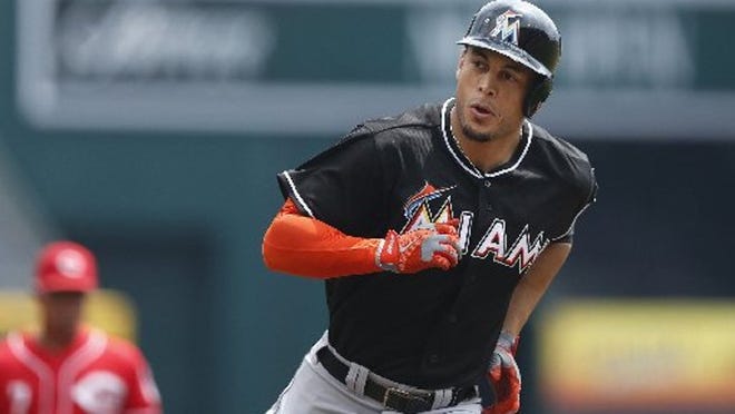 Giancarlo Stanton of the Marlins rounds the bases after hitting a home run in the first inning of the game against the Cincinnati Reds at Great American Ball Park on August 10, 2014 in Cincinnati, Ohio. (Photo by Joe Robbins/Getty Images)