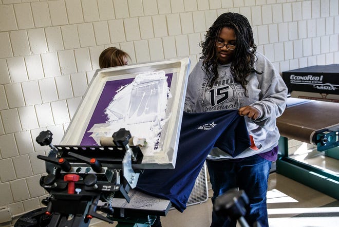Southeast High School student Corshia Taylor with Emily Hauck, a graphic designer for INK 186, to screen-print T-shirts on Friday at the United Cerebral Palsy Land of Lincoln’s workforce training center. INK 186 is a vocational training program for District 186 students with disabilities. Photos by Justin L. Fowler/The State Journal-Register