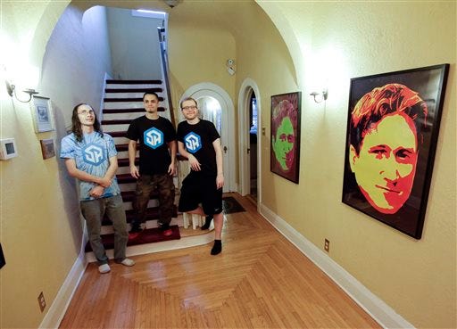 In this Nov. 6, 2014 photo, the members of StreamerHouse, from left, Brett Borden, Adam Young and Robert Schill pose for a photo in their 1920s-era Mediterranean-revival home in Lakeland, Fla. StreamerHouse, an online form of entertainment, is part Big Brother, part talk radio and part performance art. The trio play games, chat with fans and narrate their daily lives. (AP Photo/John Raoux)