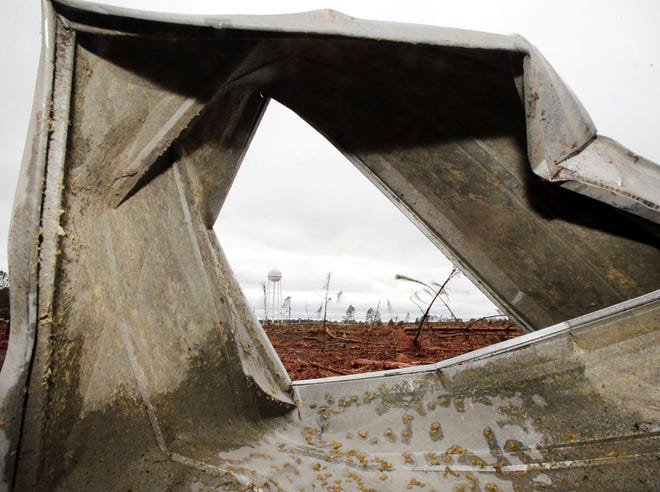 A twisted sheet of metal sits in a field after an apparent tornado touched down at the Calhoun Correctional Institution near Blountstown on Monday.