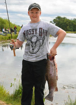Casey Gunness, 11, of McMinnville, Oregon, with a 10-pound trout he caught at family fishing event in Sheridan hosted by the Oregon Department of Fish and Wildlife. (Photo by Rick Swart/ODFW)