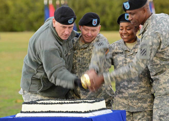 Photos by Corey Dickstein/Savannah Morning News  The 3rd Infantry Division Tuesday evening celebrated its upcoming 97th birthday during its annual Twilight Tattoo ceremony. Cutting the division's cake with a saber at Fort Stewart's Cottrell Field were, from left to right, Maj. Gen. Mike Murray, 3rd ID commander; Staff Sgt. Jose Caba, the divsion's oldest soldier; Pfc. Micah Armstrong, the 3rd ID's youngest soldier; and Command Sgt. Maj. Christopher Gilpin, the division's senior enlisted leader.