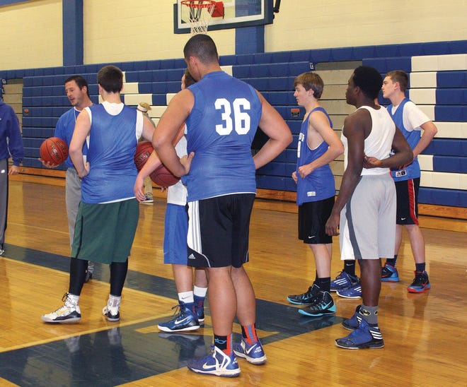Photo by Carl Pepin

Kennebunk High boys basketball coach Barrett Belanger, left, speaks with some players during Monday's first practice of the season.