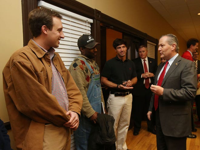 Members of the Tuscaloosa County Young Republicans, including Joe Elia, left, Kelvin Hargrove and Jesse Ochocki, speak with Alabama House Speaker Mike Hubbard at the Hotel Capstone on Wednesday.