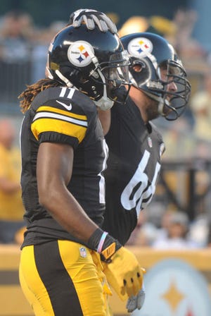 Steelers wide receiver Markus Wheaton (11) and guard David DeCastro (66) celebrate after Wheaton pulled down a touchdown catch against Buffalo last season.