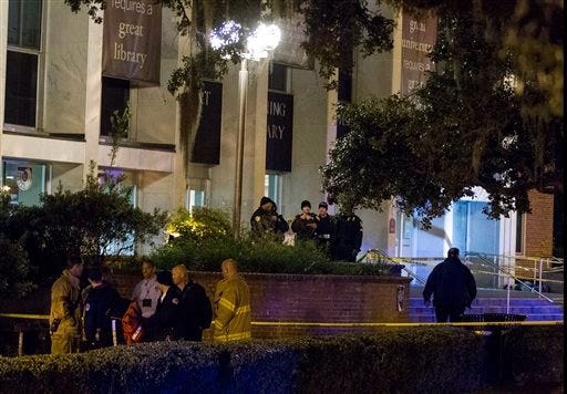 Tallahassee police investigate a shooting outside the Strozier library on the Florida State University campus in Tallahassee, Fla. Thursday Nov 20, 2014. Officers shot and killed the suspected gunman police said. (AP Photo/Mark Wallheiser)