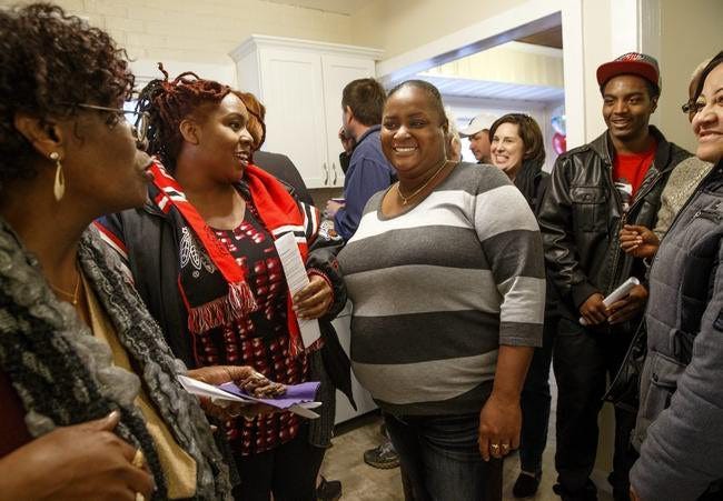 Quentyn Thomas smiles as she visits with guests Sunday in the kitchen of her new home on Henrietta Street. File/SJ-R