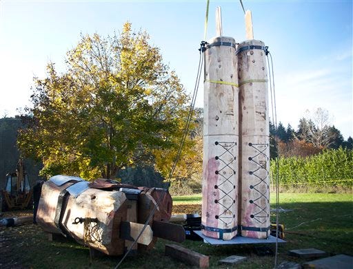 Crews begin erecting the world's tallest wooden nutcracker for the Umpqua Valley Festival of Lights, Monday Nov. 17, 2014 in Roseburg, Ore. The 41-foot nutcracker was carved with chainsaws by Toby Johnson. (AP Photo/The News-Review, Katie Alaimo)