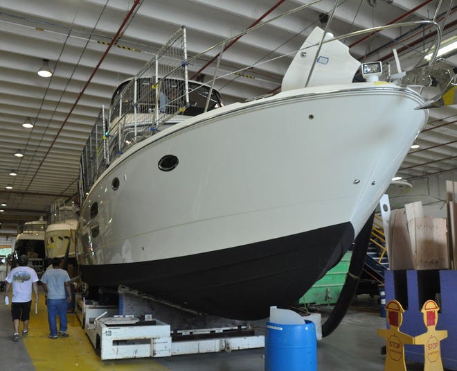 Yachts are seen on the production line at the Sea Ray Boat manufacturing facility near Flagler Beach on Tuesday. Boat sales have increased nationally and locally, prompting area builders to ramp up hiring.