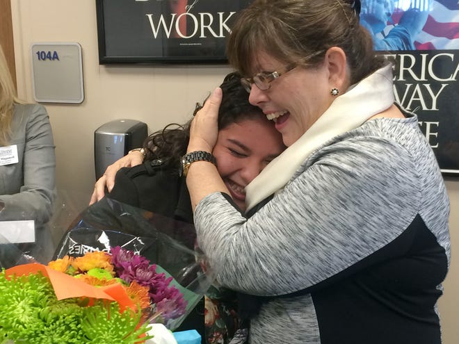 Gabby Cruz, left, a Take Stock in Children participant, gets a hug Friday from Nora Travieso after learning she is a finalist for the statewide Leaders 4 Life Fellowship program. Travieso is a program specialist with Take Stock in Children.