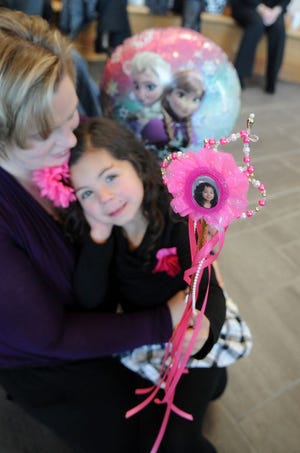 Angel, 5, of Whitman snuggles with her new mother, Jennifer Cullinan, during National Adoption Day ceremonies Friday in Brockton District Court.
