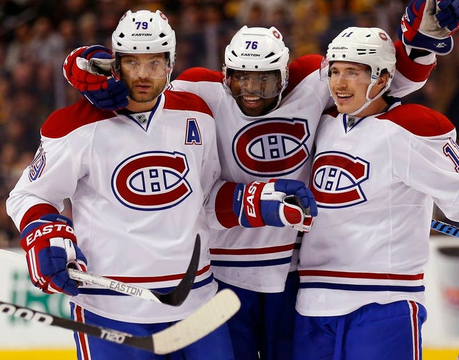 Canadiens defenseman Andrei Markov (79) celebrates his goal with teammates P.K. Subban (76) and Brendan Gallagher during the first period Saturday night.