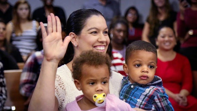 Michelle Tipping of Boca Raton adopted 2-year-olds Maggie (left) and Kyran (right) in a ceremony before Judge James Martz Friday, November 21, 2014. “They are not blood-related, but they are going to be brother and sister,” Tipping said. “I also have a son who I adopted from Guatemala when he was a year old. He’s now 9 years old, and he’s thrilled to be a big brother. Maggie’s two older brothers are being adopted today, as well. That is pretty special that we all get to do it on the same day.” Two dozen children were adopted at the Palm Beach County Courthouse on National Adoption Day. (Bruce R. Bennett / The Palm Beach Post)