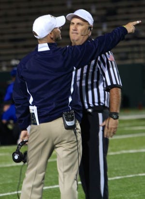 Stephenville coach Joseph Gillespie voices a difference of opinion with an official during Friday's Yellow Jacket win over Estacado. Gillespie's Yellow Jackets are one of three District 3-4A teams still alive in the postseason.