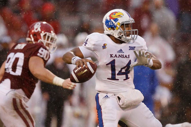 Kansas' Michael Cummings completed only 8 of 22 passes for 84 yards in poor conditions Saturday against Oklahoma.