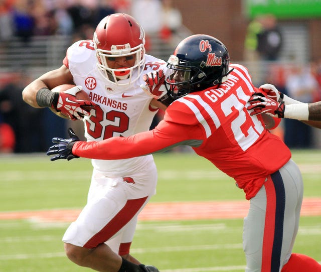 MARK BUFFALO ARKANSAS NEWS BUREAU  Arkansas running back Jonathan Williams tries to escape the tackle of Ole Miss' Senquez Golson during the second quarter on Saturday, Nov. 9, 2013, at Vaught-Hemingway Stadium in Oxford, Miss.