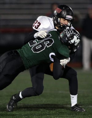 North Andover's Bill Marcotte tackles Marshfield's Jacob Maher during third quarter action in the Division 2 state semifinal game at Brockton High on Saturday, Nov. 22, 2014. Wicked Local Staff Photo/ Robin Chan