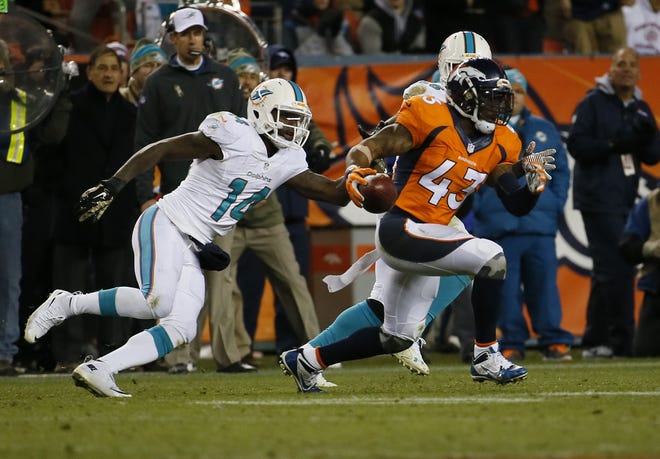 Denver strong safety T.J. Ward returns an interception that led to a touchdown during the fourth quarter of Sunday's game against Miami.