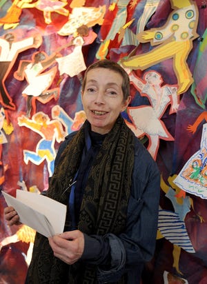 At Amazing Things Art Center, curator Olga Shmuylovich in front of "dancing," a collaborative piece from the artist therapy session.

Daily News Staff Photo/Art Illman