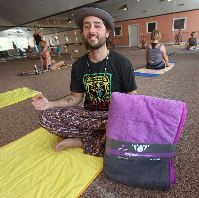 Will Jones with the WAYmat, a yoga mat he designed, at We Are Yoga, his Bikram yoga studio in Ormond Beach.