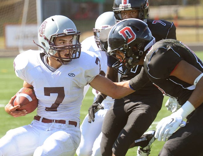 Bishop Stang's Jeff Chicca tries to hold off the Durfee defense during Saturday's game.