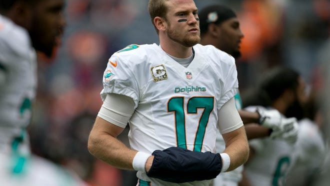 Miami Dolphins quarterback Ryan Tannehill (17) stretches before game against the Broncos at Sports Authority Field at Mile High in Denver, Colorado on November 23, 2014. (Allen Eyestone / The Palm Beach Post)