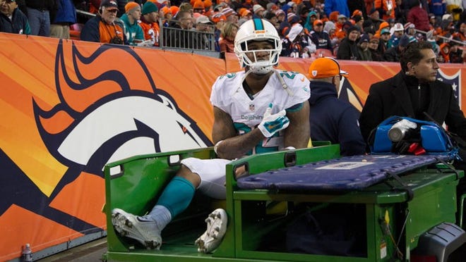 Miami Dolphins cornerback Jamar Taylor leaves the field Sunday. A source told the Palm Beach Post that he is out for the season because of a dislocated shoulder. (Allen Eyestone / The Palm Beach Post)
