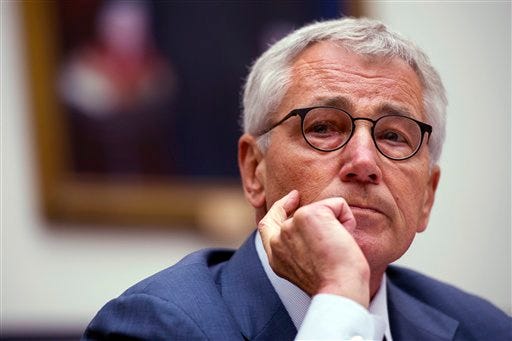In this Sept. 18, 2014 file photo, Secretary of Defense Chuck Hagel testifies before the House Armed Services Committee on Capitol Hill in Washington. Administration sources say that Defense Secretary Chuck Hagel is resigning from President Barack Obama's Cabinet. (AP Photo/Cliff Owen)