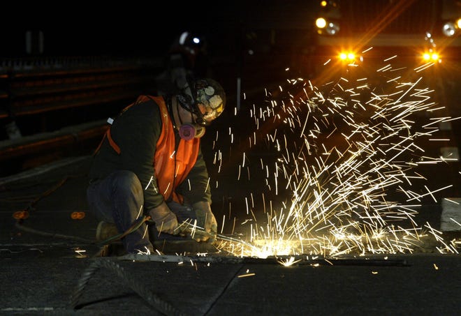 Local 417 ironworker Mike Jones of Newburgh cuts a section of the old deck loose from the Newburgh-Beacon Bridge's substructure. The three-year, $93 million redecking of the south span is scheduled to be finished next November. Times Herald-Record file photo