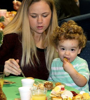 Jamie Mitchell • Times Record / Blair Griffin and her son, Cristian, 2, try some of the prepared samples Sunday during the Greenwood United Methodist Women's 31st annual "Tasting Tea" at the church. The entrees, sides, finger foods and desserts were prepared by the church members and offered at tables dressed for the Christmas season. All proceeds from the fundraiser benefit the church mission projects. 
 Jamie Mitchell • Times Record / Grayce Brown, left, and Linda Hedrick pick a few samples Sunday during the Greenwood United Methodist Women's 31st annual "Tasting Tea" at the church. The entrees, sides, finger foods and desserts were prepared by the church members and offered at tables dressed for the Christmas season. All proceeds from the fundraiser benefit the church mission projects. 
 Jamie Mitchell • Times Record / Guests make their way down the serving line to choose a few samples Sunday during the Greenwood United Methodist Women's 31st annual "Tasting Tea" at the church. The entrees, sides, finger foods and desserts were prepared by the church members and offered at tables dressed for the Christmas season. All proceeds from the fundraiser benefit the church mission projects. 
 Jamie Mitchell • Times Record / Grayce Brown, left, and Linda Hedrick pick a few samples Sunday during the Greenwood United Methodist Women's 31st annual "Tasting Tea" at the church. The entrees, sides, finger foods and desserts were prepared by the church members and offered at tables dressed for the Christmas season. All proceeds from the fundraiser benefit the church mission projects.