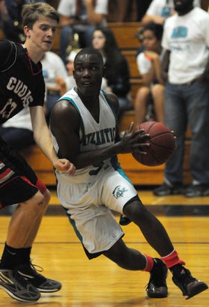Atlantic’s Cornelius Head, right, drives to the basket against New Smyrna Beach on Tuesday afternoon at Atlantic High. Head led the Sharks with 20 points.