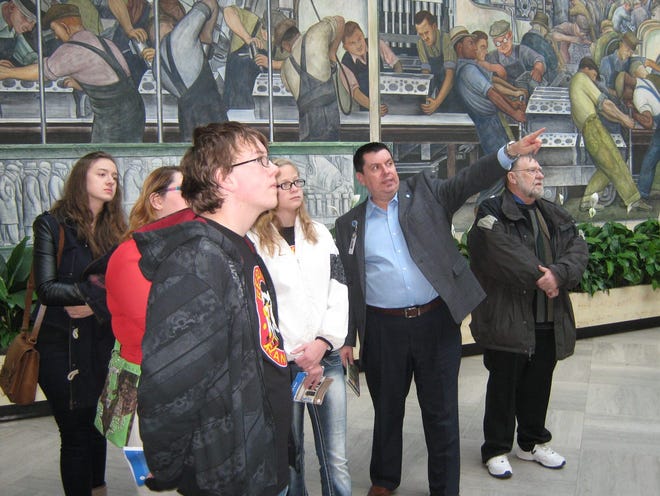 A docent at the Detroit Institute of Art discusses symbolism with the students in the murals many panels all around the room. COURTESY PHOTO