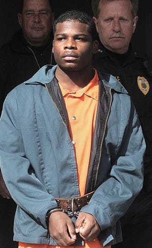 Marcel Johnson is escorted out of Judge Kline's District Court in March after a preliminary hearing in Bristol Township in this photo from March 4, 2014. Johnson has been found guilty of murdering of a pregnant woman and her young daughter.