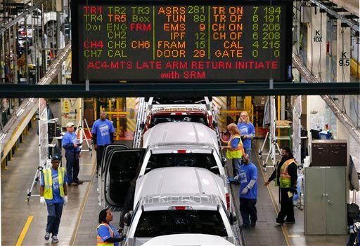 In this Nov. 11, 2014 photo, 2015 Ford F-150s move along the production line at the Dearborn Truck Plant in Dearborn, Mich. The Commerce Department releases third-quarter gross domestic product on Tuesday, Nov. 25, 2014. (AP Photo/Paul Sancya)