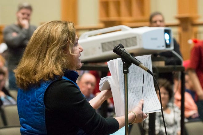 Elaine Taylor shows the petitions with over 4200 signatues that were collected to protest the recent School Committee's decision to change "Christmas Break" to "Holiday Break" during the special School Committee meeting held Monday, November 24, 2014, at Marshfield High School. Taylor said that the purpose of the Pilgrims coming to America was "to plant a colony for the Glory of God," and that "Christmas is significant."