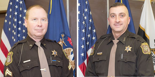 Lenawee County sheriff's Cpl. Alex Perdue, left, and Deputy Mike Osborne pulled a man from his burning home early Wednesday morning.