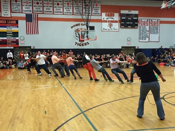 Teachers struggle in tug-of-war against a group of seniors at the spirit week pep rally at Oliver Ames High School, Wednesday, Nov. 26, 2014.