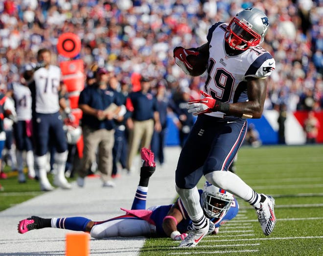 New England Patriots wide receiver Brandon LaFell (19) runs for a touchdown after breaking a tackle by Buffalo Bills' Leodis McKelvin (21) during the second half of an NFL football game Sunday, Oct. 12, 2014, in Orchard Park, N.Y.