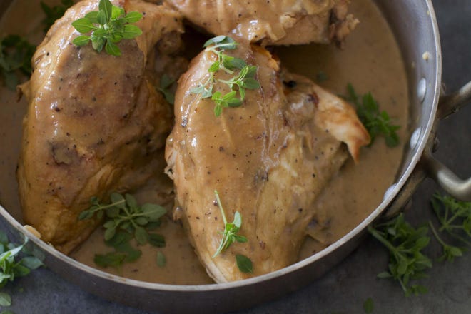 This Nov. 10, 2014, photo shows Madeira braised chicken with mushroom gravy in Concord, N.H. The braised chicken that gets a ton of flavor by cooking in a bottle of Madeira, a fortified wine from Portugal. (AP Photo/Matthew Mead)