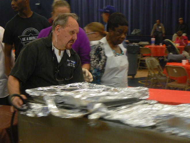 Borger brings out the food for the Thanksgiving meal at Calvary Christian Center.