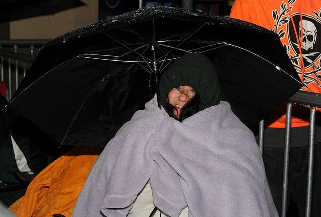 Jody Ponte sits bundled up in the wintry weather for hours, waiting to get a deal on a big-screen TV at the Swansea Walmart Black Friday sale.