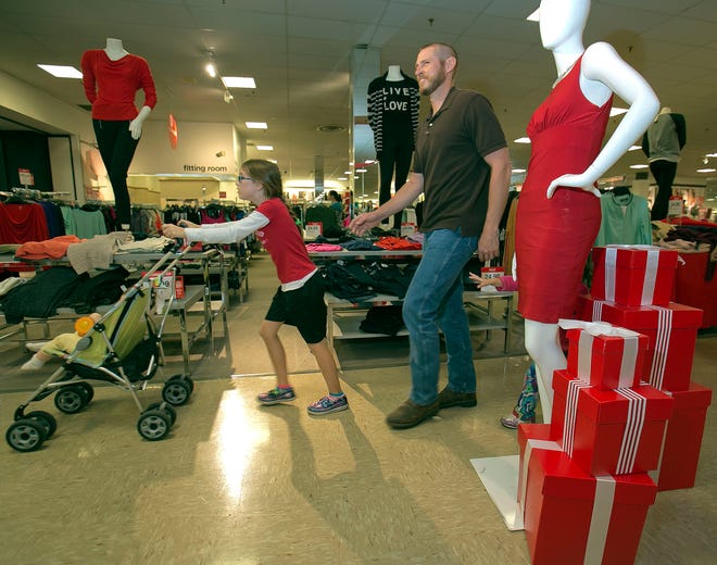 Customers shop at JC Penney store in the Paddock Mall Friday afternoon, November 21, 2014. JC Penney will open their doors at 5 p.m. on Thanksgiving day.