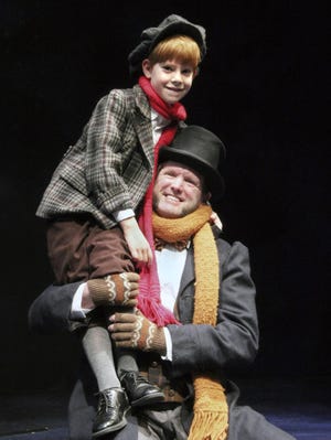 In Oregon Contemporary Theatre’s “A Christmas Carol,” Hugh Brinkley is Tiny Tim and Damon Noyes is Bob Cratchit.